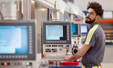 Man at a machine control panel (photo)