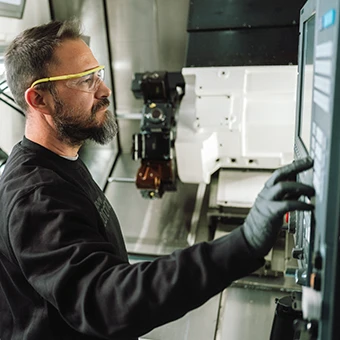 Nicola Losurdo, Center Technician, operates a CNC machine at Sandvik Coromant in Milan (Italy) (photo)