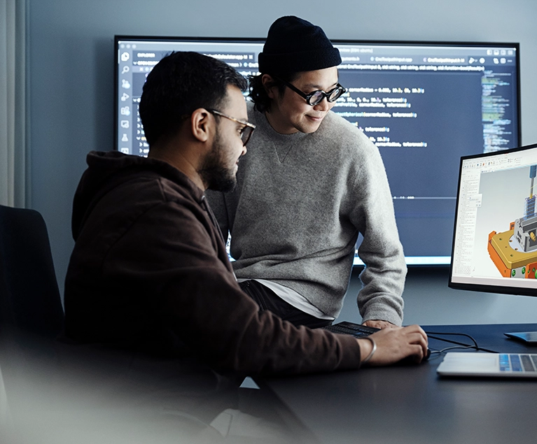 Two men looking at a computer screen with a software model (photo)