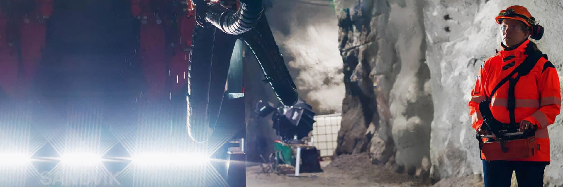 Kvinna med hjälm styr gruvmaskin i gruva med hjälp av fjärrkontroll (foto)